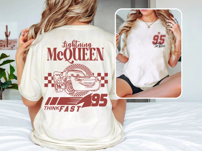 May include: White t-shirt featuring a red graphic of Lightning McQueen from the Cars film. The graphic includes the text "Lightning McQueen", "Think Fast", and the number "95".