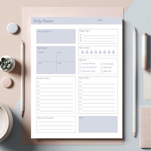 May include: A printable daily planner with sections for gratitude, top 3 priorities, meal tracking, water intake, self-care, personal to-dos, work to-dos, tomorrow's turnover, and notes.