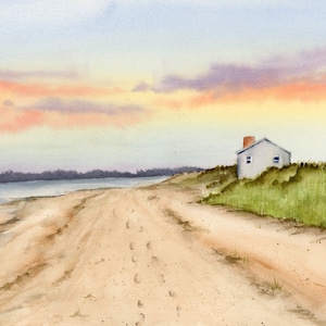 May include: A watercolor painting of a small, white cottage on a sandy beach with a path leading to it. The sky is a soft orange and purple, and the water is a light blue.