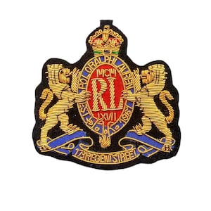 May include: Embroidered patch with a black backing, displaying a gold crown, two gold lions, and a central emblem with the text "POLO RALPH LAUREN" and "17 REGENT STREET". The emblem includes the letters "MCM" and "R" in red.
