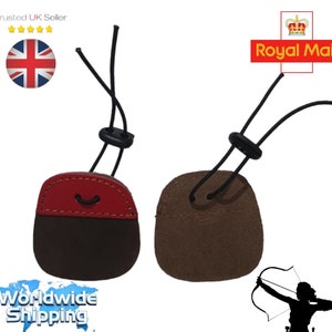 May include: Two archery finger tabs. One is red and brown, the other is brown. Each has a black cord and a black adjuster. The image also includes a silhouette of a person shooting a bow and arrow.
