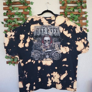 May include: Black bleached t-shirt with a graphic print of a skull and motorcycle. The graphic says "2015 Daytona Beach Annual Bike Week, World's Largest Motorcycle Rally, Since January 20, 1937".