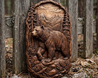 May include: A vertical, oval-shaped wooden wall plaque featuring a detailed relief carving of a bear walking through a forest. The scene includes tall pine trees, rocky terrain, and a mountain range in the background under a sunburst design.