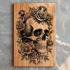May include: Wooden cutting board featuring a detailed illustration of a human skull surrounded by roses and vines. The artwork is in shades of gray and black, set against the natural wood grain.