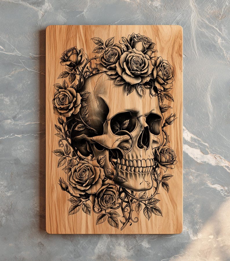 May include: Wooden cutting board featuring a detailed illustration of a human skull surrounded by roses and vines. The artwork is in shades of gray and black, set against the natural wood grain.