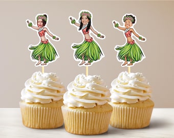 May include: Three cupcakes with white frosting and white sprinkles topped with personalized hula girl cupcake toppers. The hula girls are wearing green grass skirts, floral headbands, and red tops.