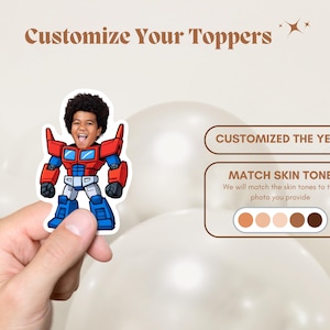 May include: A sticker featuring a child's face integrated into a cartoon robot design, with red, blue, and white accents. The text "Customize Your Toppers" is at the top. The image also includes text that says "CUSTOMIZED THE YEAR" and "MATCH SKIN TONE".