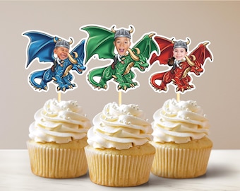 May include: Three cupcakes with white frosting topped with dragon cupcake toppers. Each topper features a different colored dragon with a child's face on the rider. The dragons are blue, green, and red.