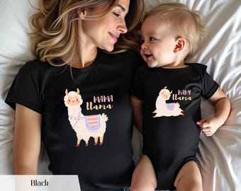 May include: Matching black t-shirt and baby onesie set with llama designs. The t-shirt reads "Mama Llama", and the onesie says "Baby Llama". Each garment features a colourful llama illustration with a pink, blue, and yellow saddle.