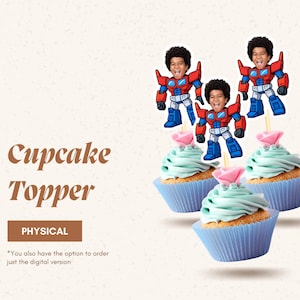 May include: Three cupcakes with blue frosting and pink flower decorations. Each cupcake is topped with a cartoon robot figure with a child's face. The image includes the text "Cupcake Topper" and "PHYSICAL".