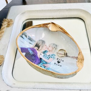 Mothers day gift photo in shell with gold trim and personalized wording.
