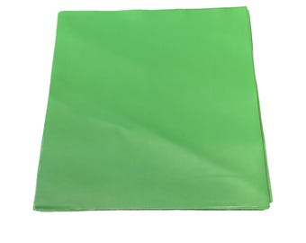 May include: A folded, bright green sheet of paper, possibly for crafting or packaging. The paper has a smooth texture and is evenly colored, with slight variations in tone due to the folds.