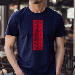May include: A navy blue t-shirt with a red embroidered design featuring geometric patterns.