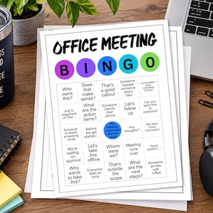 May include: A white paper sheet featuring an Office Meeting Bingo game grid with colorful circular headers for each letter. The grid contains various phrases like Who owns this, Let's follow up, and This meeting could have been an email.