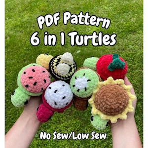 May include: A collection of six crocheted turtle toys, each designed to resemble different fruits and a sunflower. The turtles are in various colors, including green, red, yellow, and brown. The image includes the text "PDF Pattern 6 in 1 Turtles" and "No Sew/Low Sew".