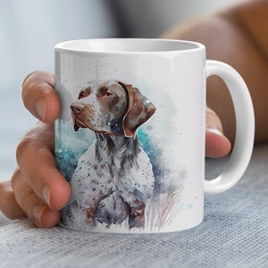 May include: White ceramic mug with a watercolor illustration of a brown and white German Shorthaired Pointer dog.
