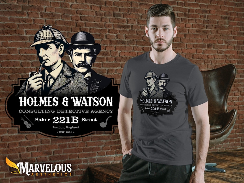 May include: A dark gray t-shirt featuring a vintage illustration of Sherlock Holmes and Dr. Watson, with the text "HOLMES & WATSON CONSULTING DETECTIVE AGENCY" and "Baker 221B Street". The design is set against a brick wall.