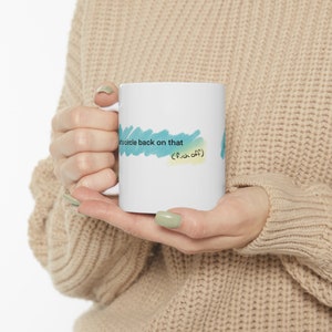 May include: White ceramic mug with a blue and green watercolor design. The text on the mug reads "Let's circle back on that (f*ck off)"