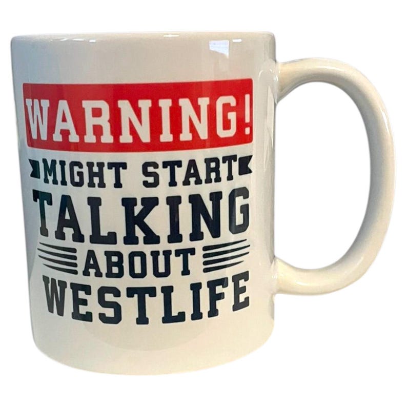 May include: White ceramic mug with a curved handle. The mug features the text "WARNING! MIGHT START TALKING ABOUT WESTLIFE" in black and red block letters. The mug is designed for beverage consumption.