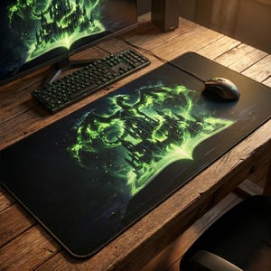 May include: A black rectangular gaming mouse pad featuring a fantasy castle design with a green, glowing dragon and castle illustration. A black mouse and keyboard are also visible on a wooden desk. The mouse pad is designed for gaming.