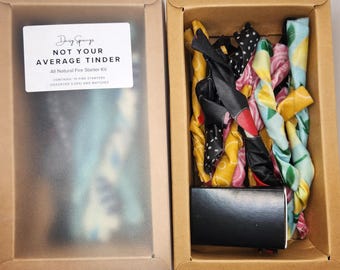 May include: A box of all-natural fire starters, called "Not Your Average Tinder", with a variety of colorful fabric fire starters and matches. The box is labeled with the brand name "Daisy Springs".