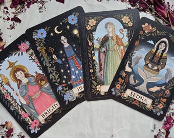 May include: Four tarot cards with illustrations of female figures. The cards feature floral borders and the names "BRIGID", "HECATE", and "SEDNA". The artwork includes celestial elements, keys, and a serpent, with a color palette of black, blue, pink, and gold.