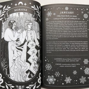 May include: An open book with black pages and white ink illustrations. The left page features a detailed drawing of two figures labeled Morana, surrounded by flames and snakes. The right page contains text about January, snowflakes, and goddess attributes.
