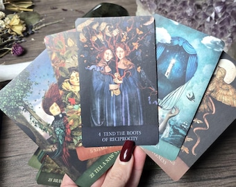 May include: A set of tarot cards with colorful illustrations and text. The cards are fanned out in a hand, showing the front of each card. The cards feature images of trees, owls, and other nature-inspired imagery. The text on the cards includes the number 4 and the words "Tend the Roots of Reciprocity".