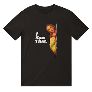 May include: Black t-shirt with a white graphic of Jesus peeking around a corner and the text "I Saw That."