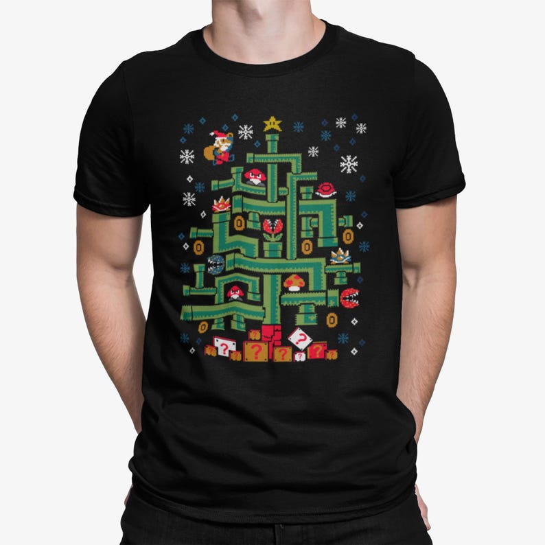May include: Black t-shirt featuring a pixelated Christmas tree design inspired by the Super Mario Bros. video game. The tree is composed of green pipes, with characters and elements from the game, and snowflakes. A star tops the tree.