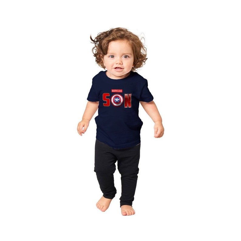 May include: A navy blue toddler t-shirt with a red and white Captain America shield graphic and the text "MARVELOUS SON".