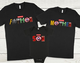 May include: Three black t-shirts with a Marvel theme. The shirts say "Marvelous Father", "Marvelous Mother", and "Marvelous Son" with superhero logos.