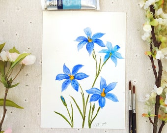 May include: Watercolour painting of blue flowers with green stems and leaves on a white background. The painting is signed "M.K.T. 2022".