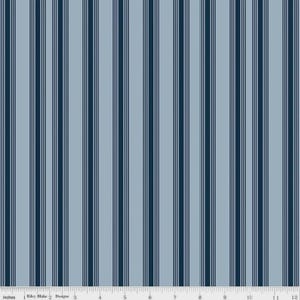 May include: A fabric with a vertical stripe pattern. The design features alternating stripes of light blue, navy blue, and thin white lines. The image includes an inch ruler along the bottom edge.
