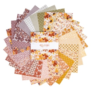 May include: A collection of fabric squares in various patterns and colors, arranged in a circular display. The fabrics feature floral, plaid, and geometric designs in shades of orange, yellow, brown, and pink. A central stack of fabric squares has a white band with floral text.