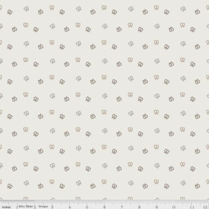 May include: Cream-colored fabric with a repeating pattern of small pretzel shapes in shades of brown and gray. The fabric has a subtle texture and is suitable for various sewing projects. The pattern is evenly spaced across the fabric.