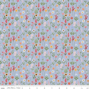 May include: A blue fabric with a repeating pattern of small pink, red, yellow, and white flowers. The flowers are arranged in a random pattern on a light blue background.