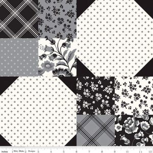 May include: A patchwork fabric featuring various black, white, and gray patterns. Designs include floral prints, plaid, and small dot patterns. The fabric is measured in inches, with a ruler along the bottom edge.