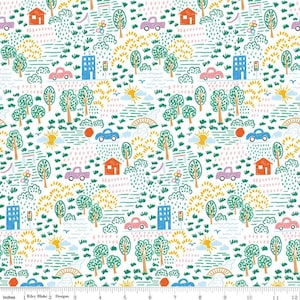 May include: A white fabric with a repeating pattern of a whimsical town scene. The design includes houses, cars, trees, and suns in shades of red, blue, green, yellow, and pink. The text "Riley Blake Designs" is visible at the bottom.