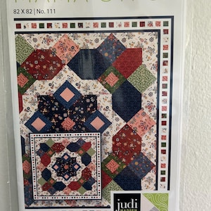 May include: A quilt pattern titled "MAMA GYPSY" with a colorful patchwork design. The quilt measures 82 x 82 inches and features a mix of floral and geometric patterns in shades of red, blue, green, and pink. The pattern is by Judi Madsen Designs.