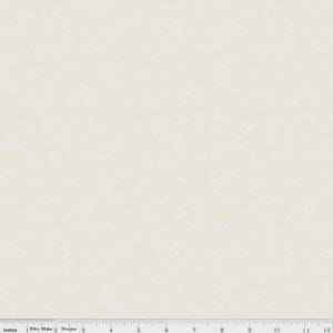 May include: Cream-colored fabric with a subtle, all-over floral pattern. The design features delicate, white floral motifs scattered across the surface. The fabric is measured in inches, with a ruler along the bottom edge.