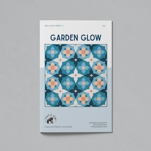 May include: A quilt pattern titled "Garden Glow" with a geometric design in shades of blue, teal, and peach. The pattern is by Taylor Krz and features the Toad & Sew logo. The skill level is indicated by five stars.
