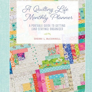 May include: A quilting life monthly planner with a colorful patchwork quilt design. The cover features the text "A Quilting Life Monthly Planner" and "A portable guide to getting (and staying) organized" by Sherri L. McConnell.