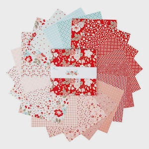 May include: A collection of fabric squares in various patterns and colors, including red floral, light blue geometric, and pink floral designs. The squares are arranged in a circular pattern, with a central stack wrapped with a white band featuring floral accents.