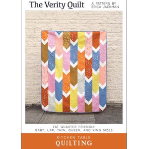 May include: A quilt pattern called "The Verity Quilt" by Erica Jackman. The quilt is made with fat quarters and features a chevron pattern in shades of pink, yellow, blue, orange, and brown. The pattern is available in baby, lap, twin, queen, and king sizes.