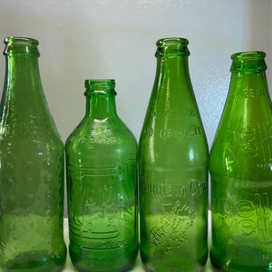 Lot of 4 Vintage Soda Bottles, 70’s Mountain Dew, Mello Yello, 7-Up and Sprite