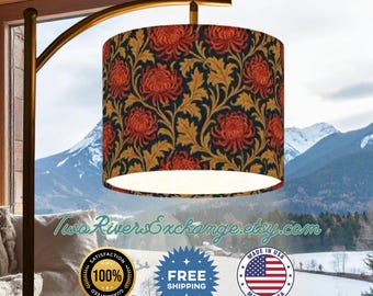 May include: A gold-toned arc floor lamp with a cylindrical lampshade. The lampshade features a floral pattern with red chrysanthemums and gold leaves on a dark blue background. The text "Two Rivers Exchange.etsy.com" is visible.