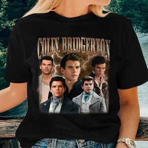 a woman wearing a black t - shirt with a picture of two men on it