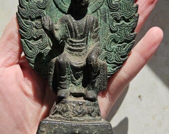 Old ancient Buddhist statue, bronze Buddha