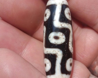Worn 9 eyes dzi bead from Tibetan people in Nepal.